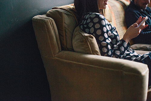 person sitting on a couch with a phone